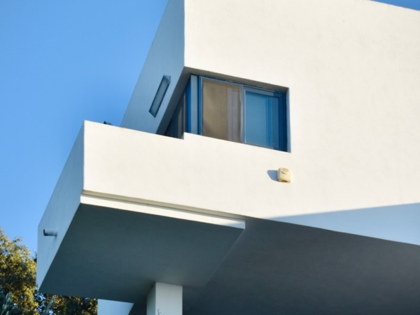 white concrete building with blue window