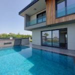 a house with a swimming pool in front of it