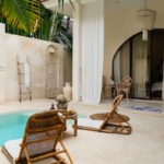 A pool with a chair and a table next to it