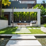 A modern house with a pool in front of it